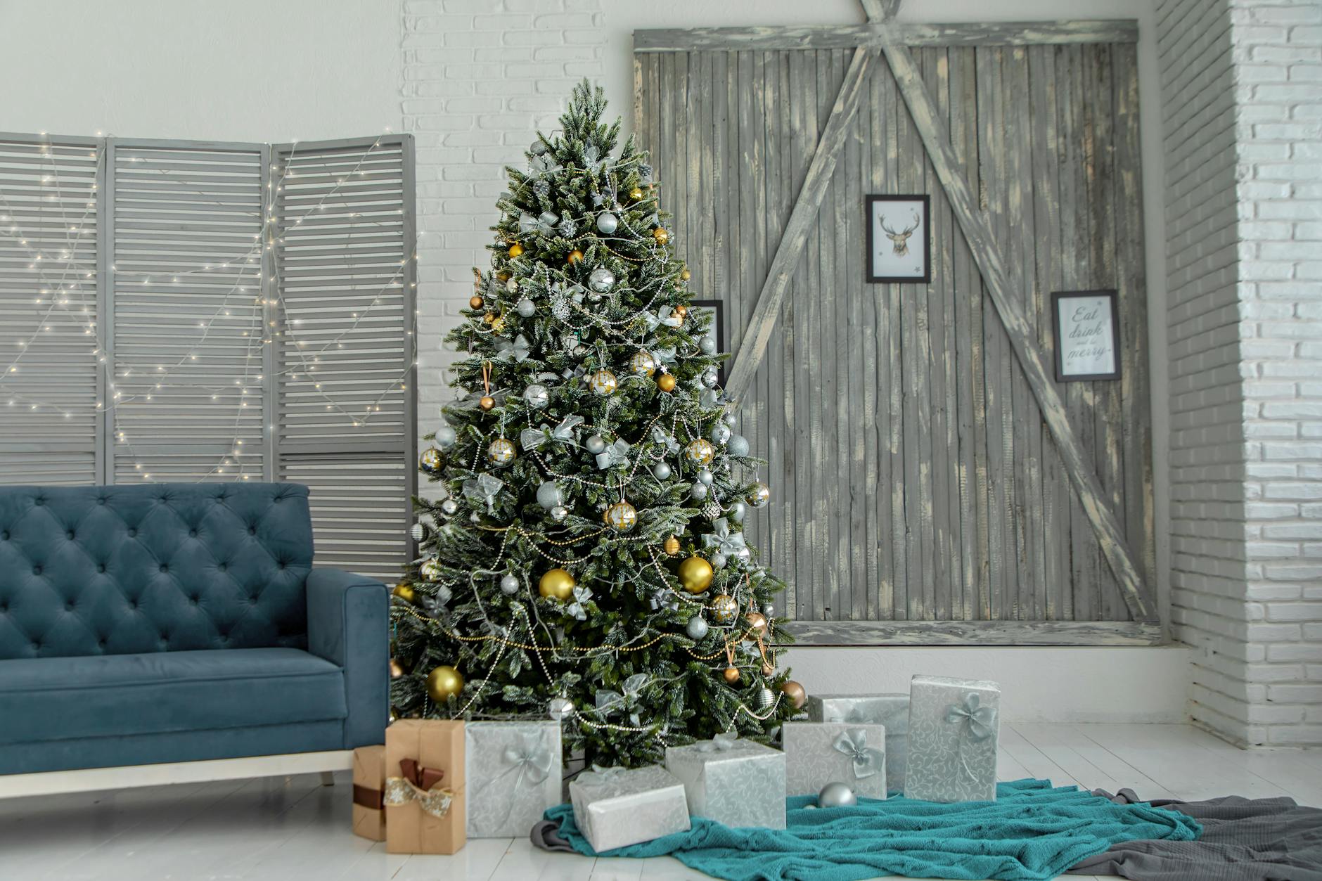 green christmas tree with gray gift boxes near sofa