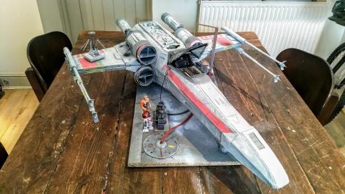 Star Wars X-Wing fighter model, which was scratch built using a variety of simple materials